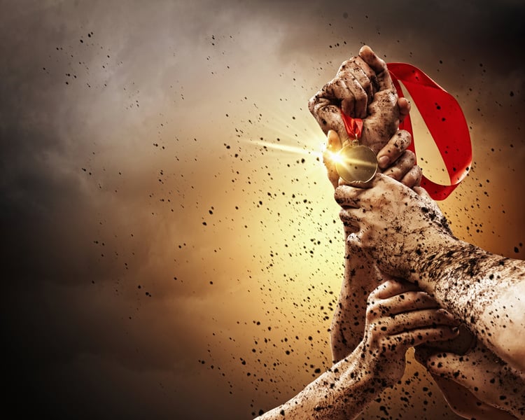 Hands tighten medal in a dark stormy sky.